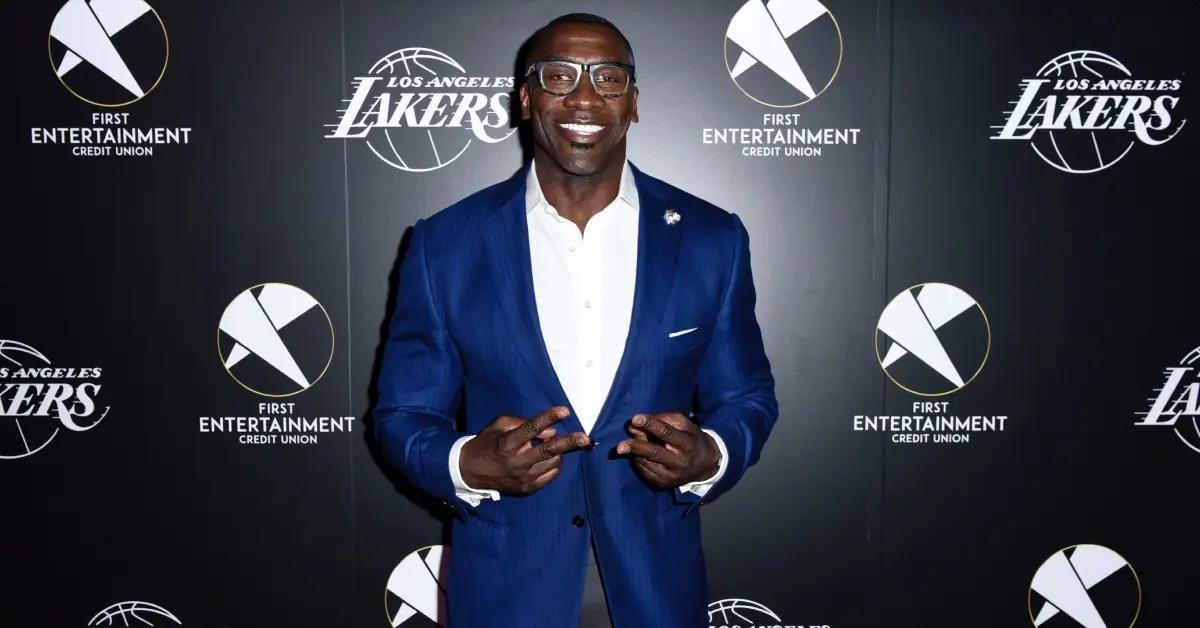 Shannon Sharpe in a blue suit and white shirt.